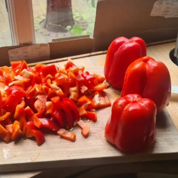 Red bell peppers on a cutting board