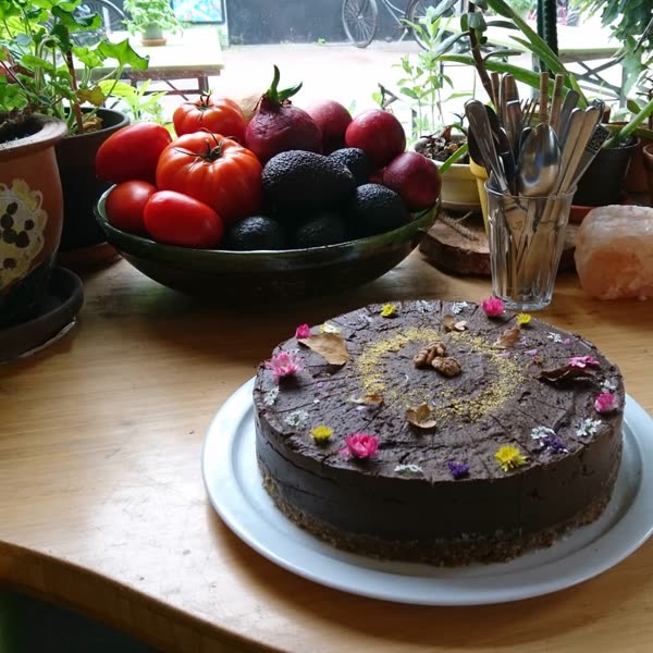 Raw chocolate cake with edible flowers